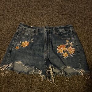 High waisted blue denim shorts with flowers.Brand American Eagle outfitters.